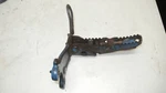1989 Suzuki Quadsport Right Foot Peg Rest Assembly Used. Price: $25.00.
